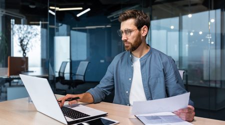 Man working on laptop in modern office